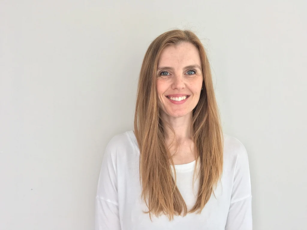 Dr. Erika Penner, smiling, in a white top